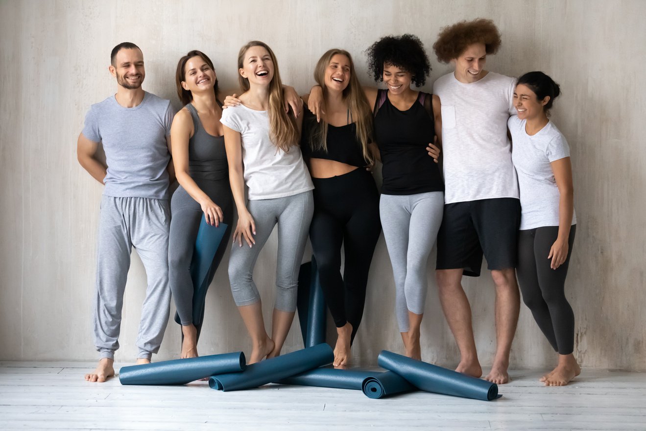 Happy diverse friends having fun after yoga training together